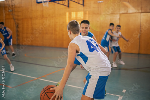A young basketball team is practicing game strategy on training.