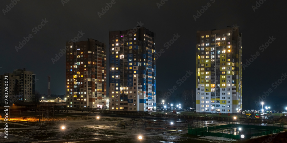 with light in windows of multistory buildings at night. life in a big city. Serenade of light