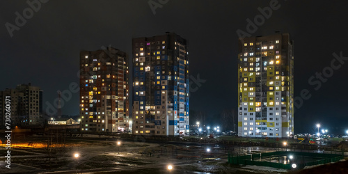 with light in windows of multistory buildings at night. life in a big city. Serenade of light © hiv360