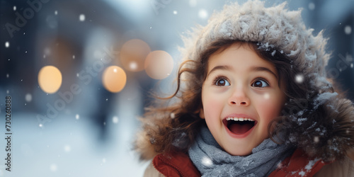 Banner with cute excited girl with snowy copy space as the background. Shallow depth of field.