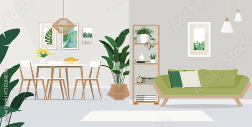 Wooden table and green couch in spacious living room interior with plants and lamps.