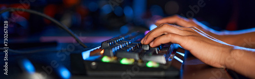 cropped female hands typing on computer keyboard with illumination while playing game, banner