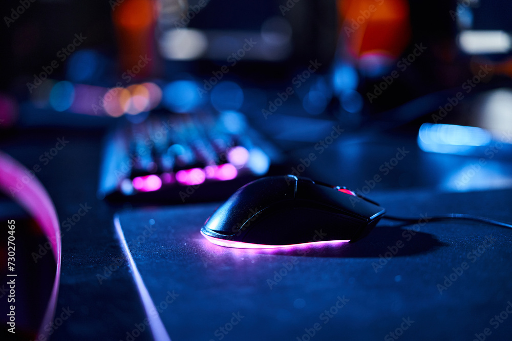 close up of illuminated computer mouse near computer keyboard, cybersport and gaming accessories close up of illuminated computer mouse near computer keyboard, cybersport and gaming accessories