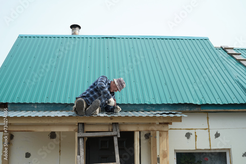 A diligent man repairs a roof, securing his home against the elements. This image speaks to the enduring value of hands-on work and self-reliance.