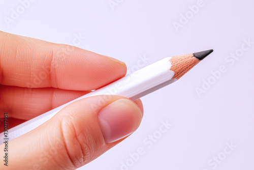 Hand holding a white pencil, business economy financial concept