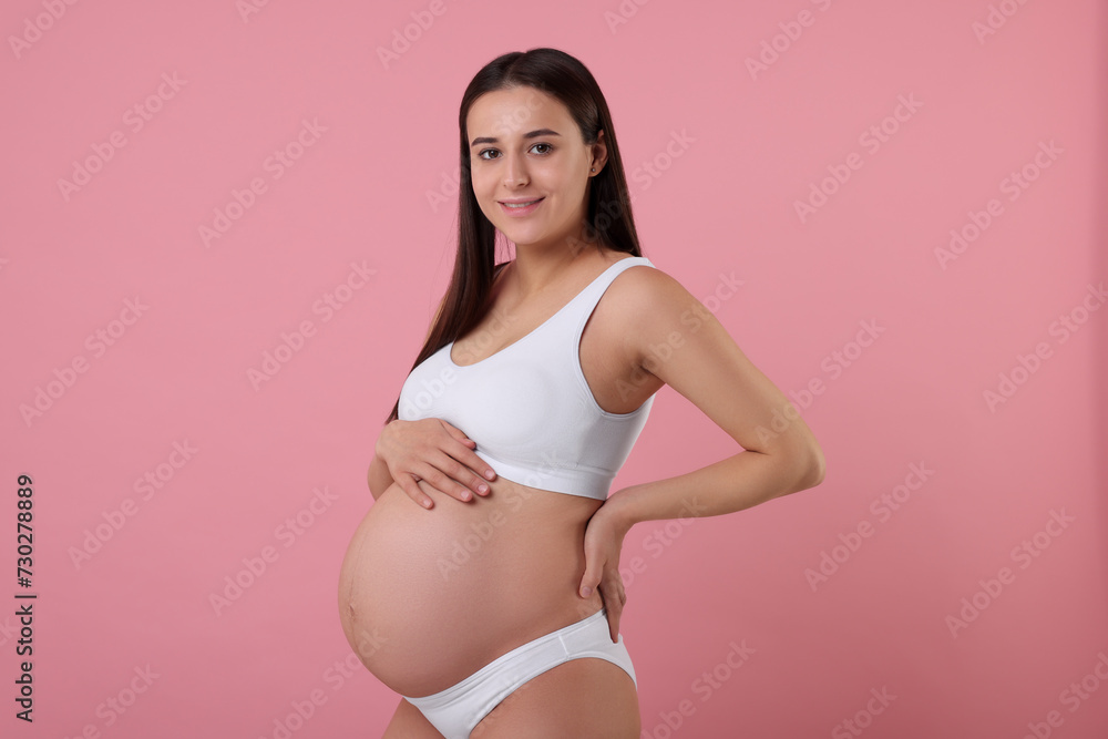 Beautiful pregnant woman in stylish comfortable underwear on pink background Beautiful pregnant woman in stylish comfortable underwear on pink background