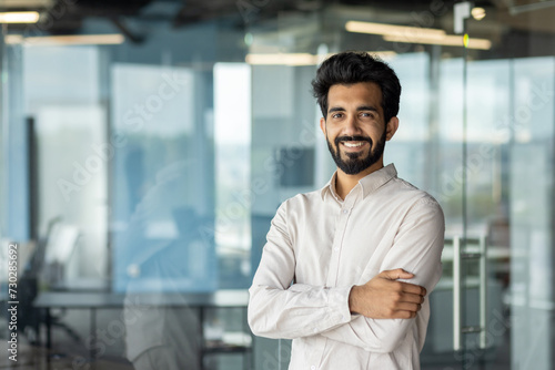 Confident indian businessman smiling in modern office setting  corporate professional portrait