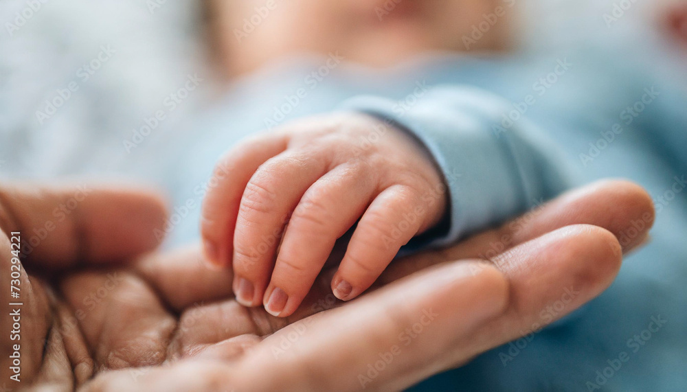 Newborn baby's tiny hand gently folded over adult's hand, symbolizing love, guidance, and new beginnings Newborn baby's tiny hand gently folded over adult's hand, symbolizing love, guidance, and new beginnings
