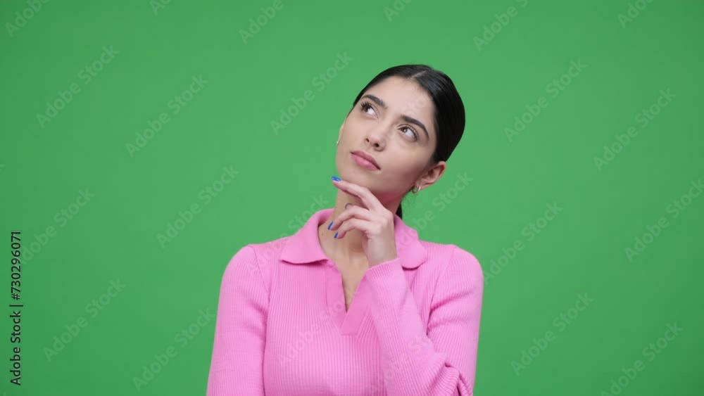 Thoughtful Caucasian woman in doubt with brilliant idea over green background. Finding solution, searching answer to question, pointing finger up. Thoughtful Caucasian woman in doubt with brilliant idea over green background. Finding solution, searching answer to question, pointing finger up.