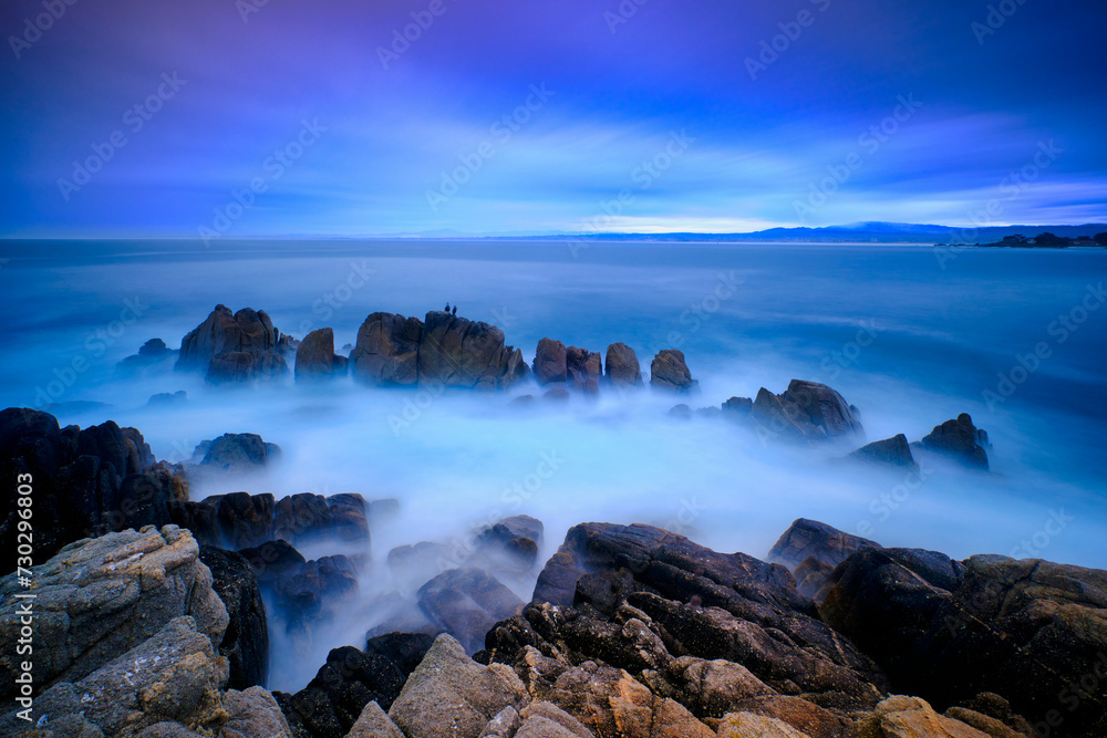 Obraz premium Moody blue hour sunrise on the coastline of Pacific Grove, California. 