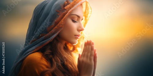 woman with head covered in scarf praying to God , Christianity and religion background, faith and redemtion banner photo