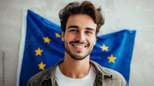 Young man with the EU flag in the background. 
