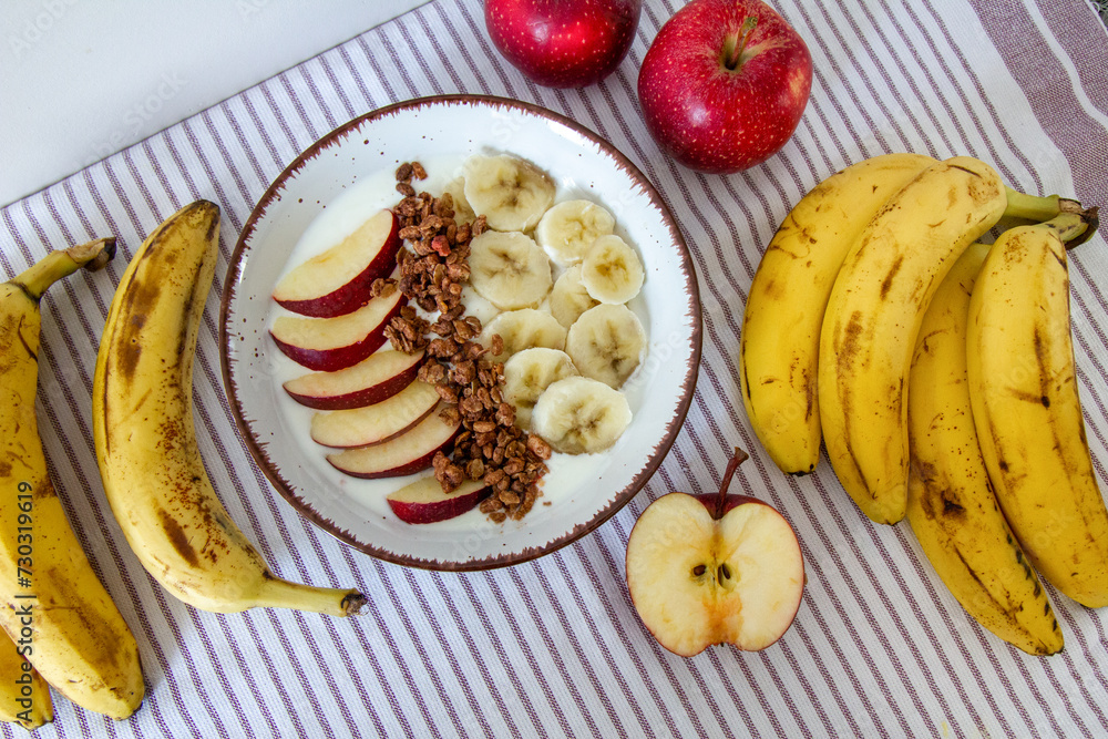Healthy breakfast with natural yogurt, granola, apple and bananas Healthy breakfast with natural yogurt, granola, apple and bananas