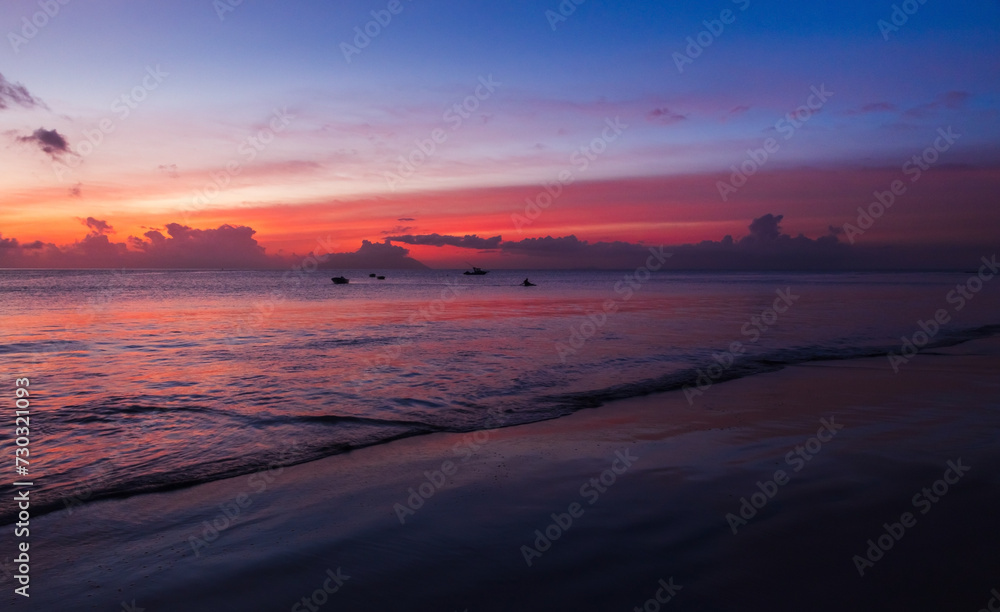 Seaside landscape, shore water under colorful sky at sunset