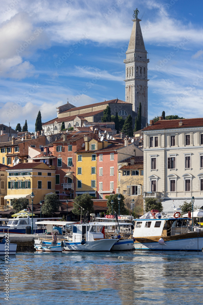 Colorful tenement houses on the boulevard by the port over Adriatic Sea, moored boats, Rovinj, Croatia, Istria