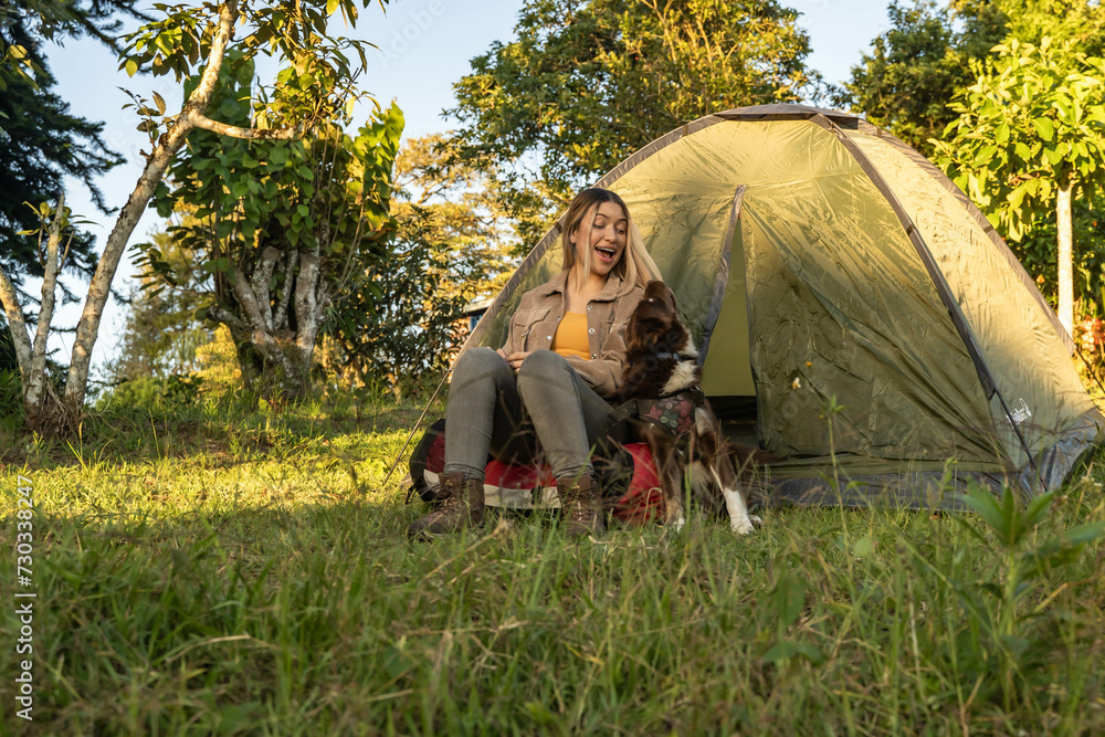 latina woman camping with her dog