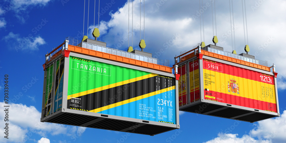 Shipping containers with flags of Tanzania and Spain - 3D illustration