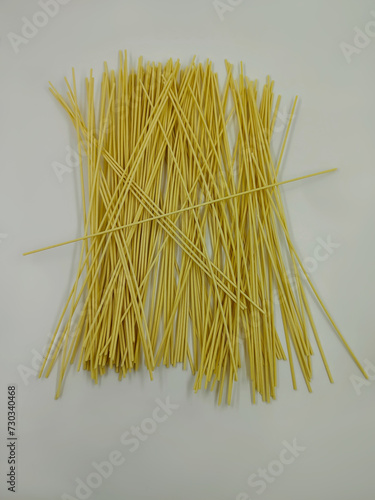 a bunch of uncooked oven noodles with a white background  photo