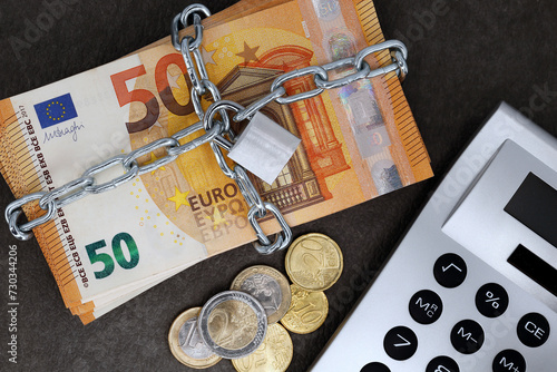 Canvastavla A stack of cash with 50 euro banknotes is locked with a chain and padlock next t