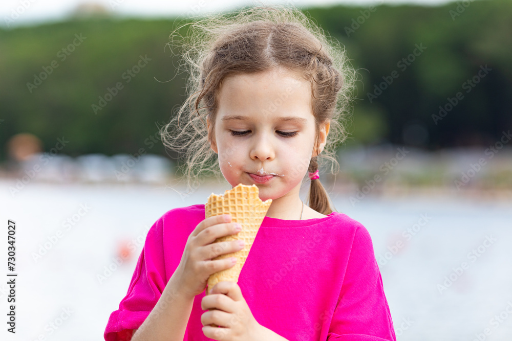 Portrait of a cute girl with ice cream on a walk in the park. child outdoors Portrait of a cute girl with ice cream on a walk in the park. child outdoors