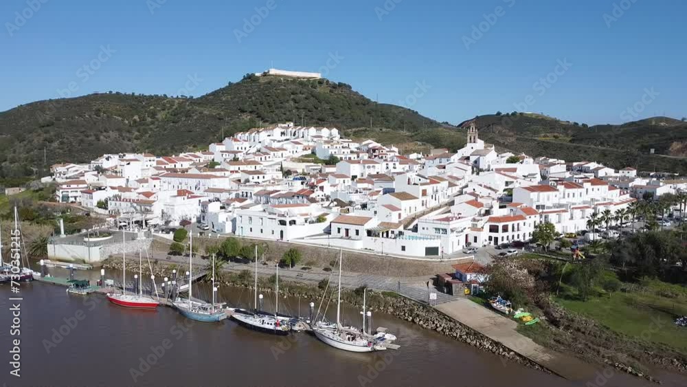 Aerial drone view of Sanlucar de Guadiana village in Huelva, Andalusia, on the banks of Guadiana river, in the border of spain with portugal, in front of the portuguese village of Alcoutim in Algarve Aerial drone view of Sanlucar de Guadiana village in Huelva, Andalusia, on the banks of Guadiana river, in the border of spain with portugal, in front of the portuguese village of Alcoutim in Algarve