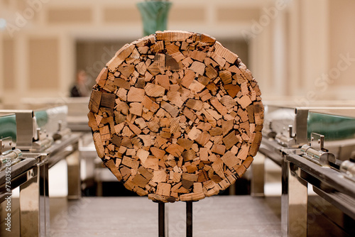 Decorative Objects for Interior Design Made from Wood. Handcrafted Decoration made of Wood. Chopped Wood Compiled into a Circular shape. Texture,