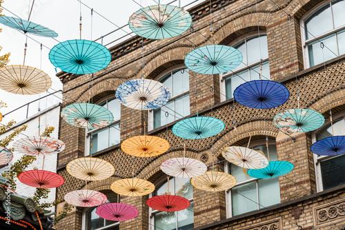Umbrellas hanging over street in Chinatown in London photo