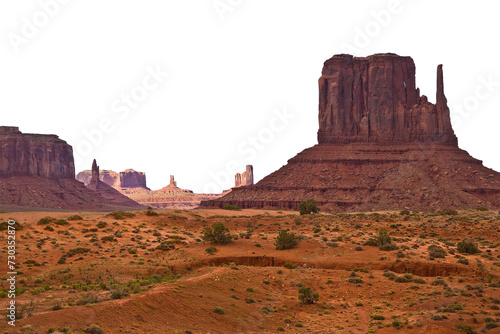 The Monument Valley in Utah–Arizona state with the crossing road in the desert - The valley is considered sacred by the Navajo Nation - USA - Cutout concept with no sky for white background copyspace