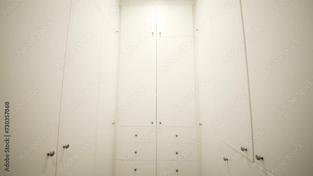 Simple modern white wardrobe with many drawers in apartment Simple modern white wardrobe with many drawers in apartment