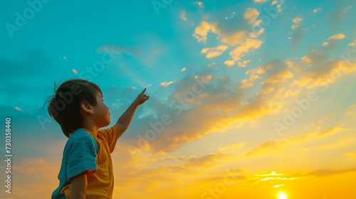 Little kid pointing at the sky, symbolizing hope future and growth