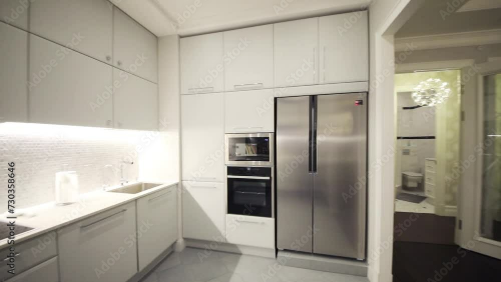 Empty modern white kitchen with built-in appliances in apartment Empty modern white kitchen with built-in appliances in apartment