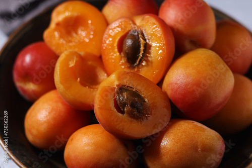 Fresh ripe apricots in bowl in rustic style