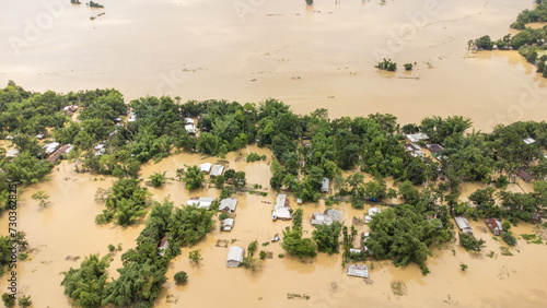 Photography Aerial view of small town been Flooded countryside neighbourhood in Silchar, Assam India Barak River at 19 May 2022 Homes, houses overflowing muddy water concept of nature disaster climate change