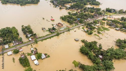Photography Aerial view of small town been Flooded countryside neighbourhood in Silchar, Assam India Barak River at 19 May 2022 Homes, houses overflowing muddy water concept of nature disaster climate change