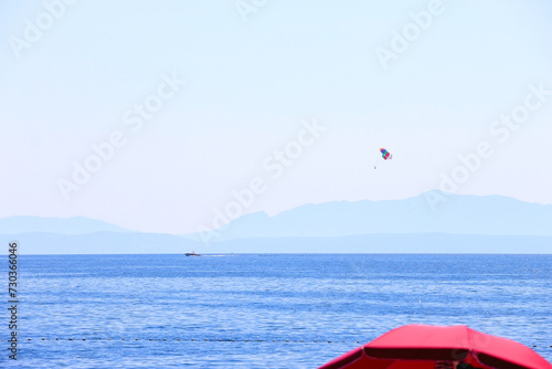 Beautiful seaside landscape and parasailing parachute in Brela, Croatia. photo