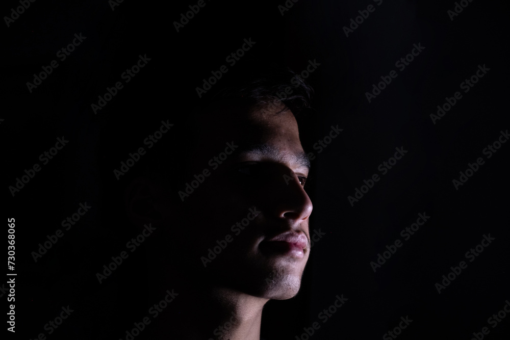 Naklejka premium Portrait for teenager in dark and light studio
