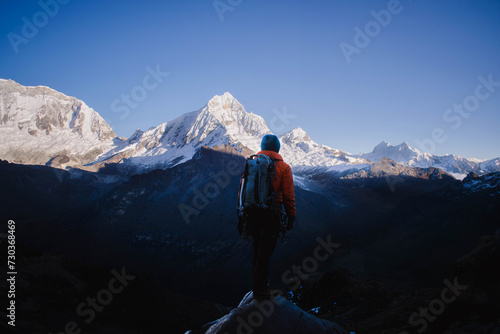 man standing in front of the mountain