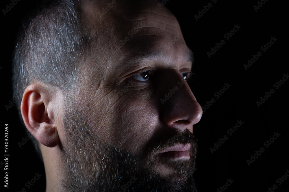 portrait for man in dark and light in middle age with face expression portrait for man in dark and light in middle age with face expression