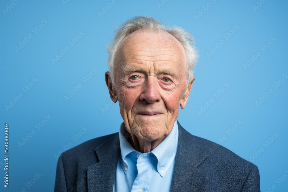 Portrait of senior man looking at the camera on a blue background Portrait of senior man looking at the camera on a blue background