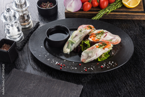 Spring rolls with vegetables on a black table