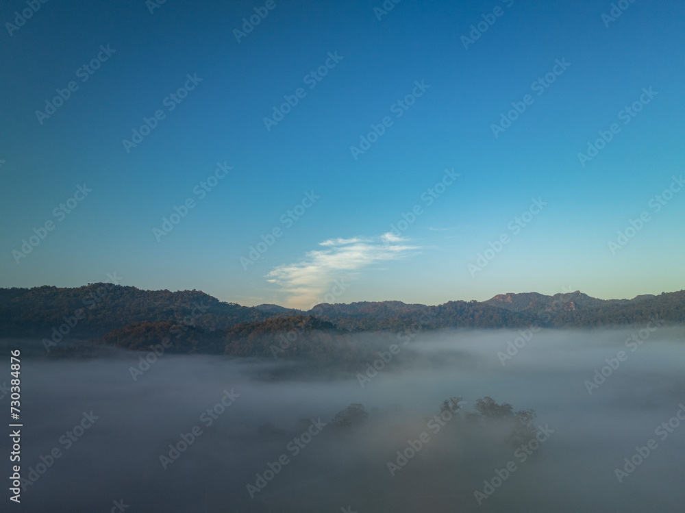 Aerial view scenery sunrise above the sea of mist...Nestled amidst the untouched beauty of Tak Province, ..Thi Lo Su Waterfall stands tall as a hidden gem within Umphang Wildlife Sanctuary...