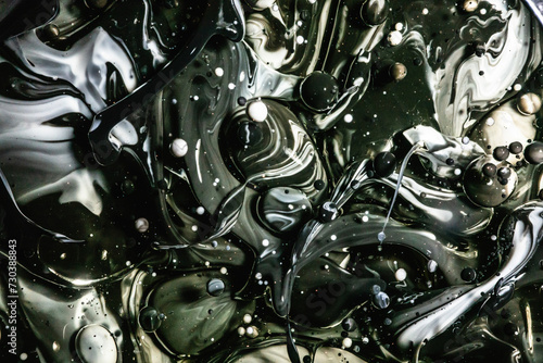A monochromatic palette of black and gray swirls with scattered bubbles creates a sleek and modern abstract design photo