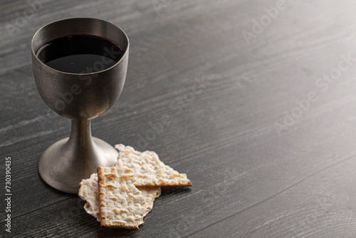 Photography Holy Communion in a Pewter Goblet with an Antique Bible on a Wooden Table