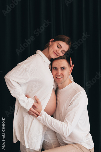 pregnant wife and husband hugging at home