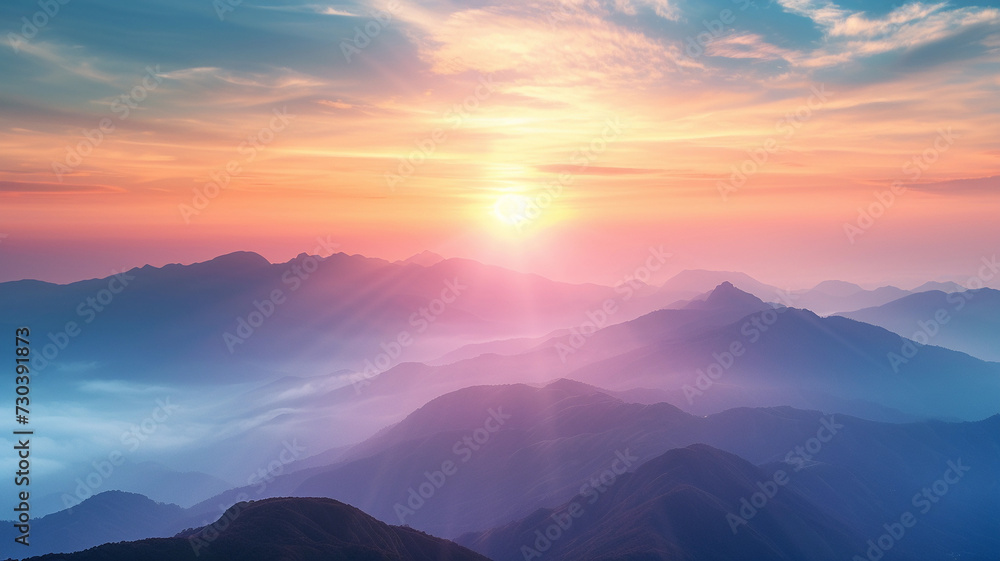 The sun over a majestic mountain blue range. Misty nature background.