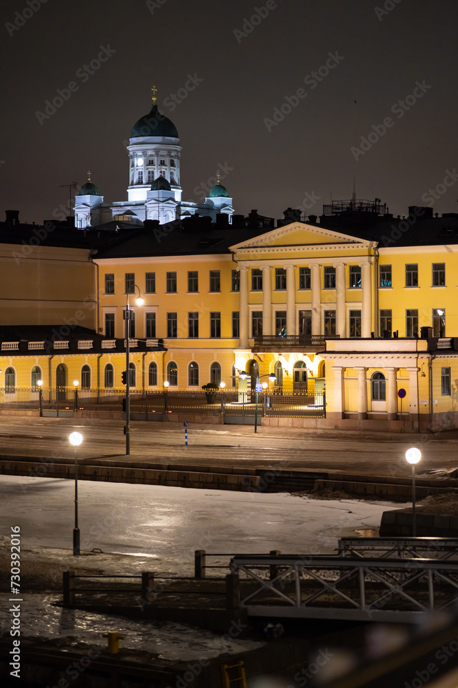 Helsinki Presidential palace during night-time with Helsinki cathedral shining in the background