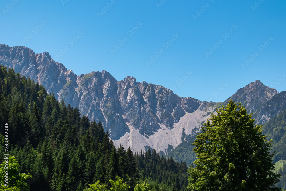 Panoramic view of majestic mountain ridges of Karawanks in Bodental, Carinthia, Austria. Looking at majestic summit of Vertatscha and Hochstuhl. Remote alpine landscape in Austrian Alps in summer
