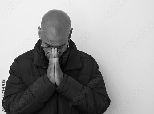 black man praying to god with black grey background with people stock image stock photo