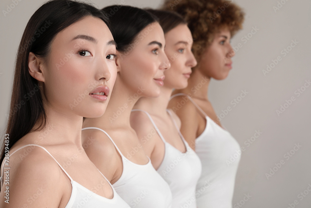 Beautiful young women with healthy skin on gray background Beautiful young women with healthy skin on gray background
