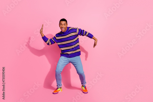 Full length photo of cool funky man wear striped sweater having fun empty space isolated pink color background